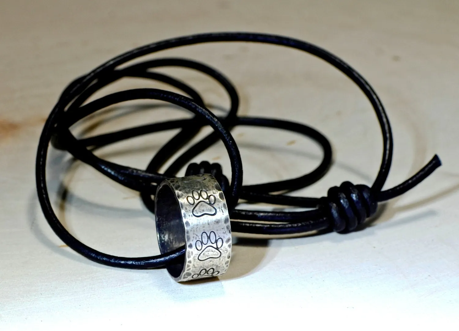 Hammered sterling silver paw ring necklace with rustic dark patina